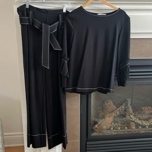 Rinascimento trousers and top in black with white stitching